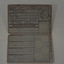 Small folded cardboard of grey colour with pale blue background in centre.  Has black lettering and crest.