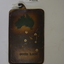 Brown leather pouch contains a silver piece of metal used as a shaving mirror.