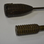 Long metal rod with round grenade attached at one end.