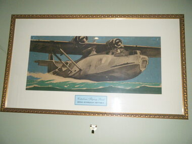 Gold painted embossed metal frame containing watercolour painting of plane on water