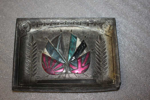 Small rectangular metal plate with enamel coloured flags