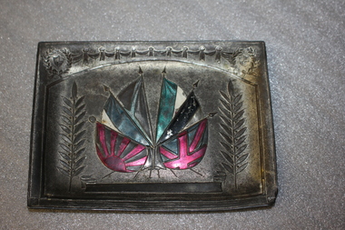 Small rectangular metal plate with enamel coloured flags
