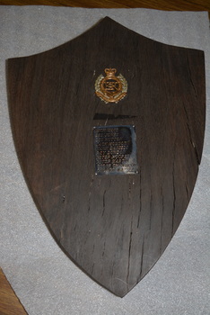 Black painted cylindrical instrument with glass face .  There is a side cutout containing  metal parts .