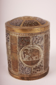Round metal container with fitted lid ornately engraved with elephants