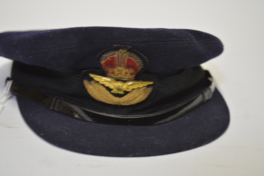 Dark blue felt RAAF Officer’s hat with emblem/crown above wings at front above peak.