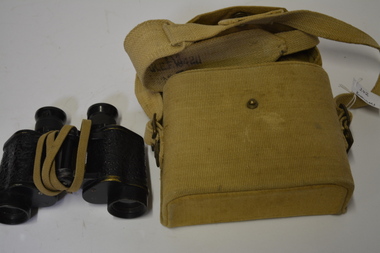 Khaki/light brown coloured canvass case with carry strap containing metal Binoculars