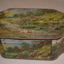 Coloured metal tin depicting English cottage scene containing poems and a letter