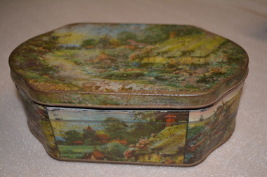 Coloured metal tin depicting English cottage scene containing poems and a letter