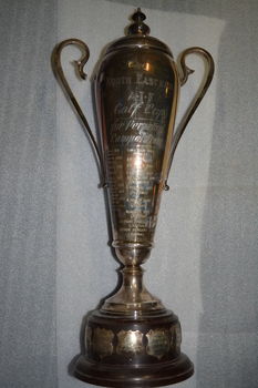 Silver plated trophy with lid and side arms mounted on brown plastic base