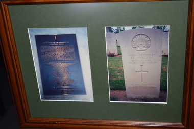 Brown timber frame with green mount containing two photographs -  of a plaque and gravestone