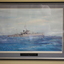 Brown timber frame containing print of ship at sea 