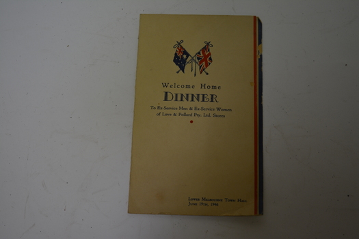 Bone coloured card with red and blue stripes at right hand side.  Australian and Union Jack flags at top with blue writing.