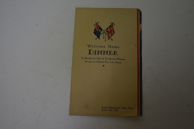Bone coloured card with red and blue stripes at right hand side.  Australian and Union Jack flags at top with blue writing.