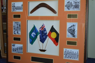 Large  timber frame with orange mount containing boomerang three flags six photographs and narrative plaques
