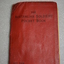 Small red book with plastic canvas cover with black writing on cover