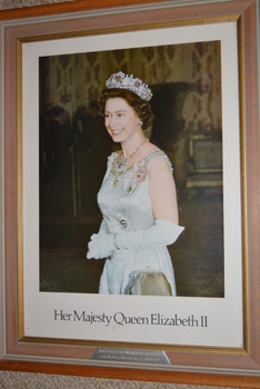Light brown timber and gold gilt inner edge frame containing print of lady wearing evening dress with diamond and ruby tiara