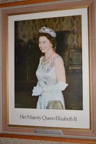 Light brown timber and gold gilt inner edge frame containing print of lady wearing evening dress with diamond and ruby tiara