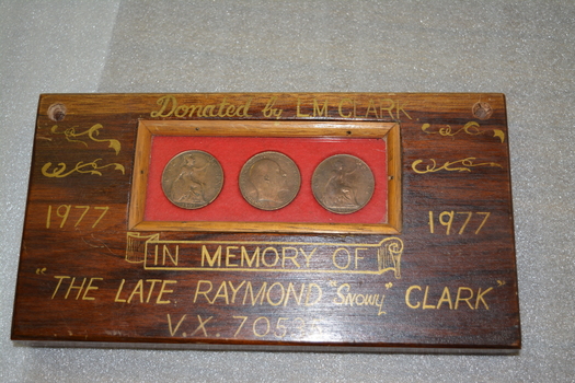 Hand made  timber block with insert containing three brown coins on red background