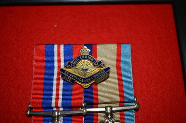 Gold coloured metal and blue badge with crown on top