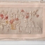 White rectangular postcard with embroidered beige, brown and yellow flower and foliate decoration on front.  