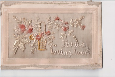 White rectangular postcard with embroidered beige, brown and yellow flower and foliate decoration on front.  