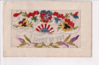 White rectangular postcard with embroidered flowers and green foliate decoration on front. 