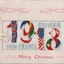 White rectangular bi-fold card with window mounted embroidery of the colours and flags of different countries in the shape of 1918.