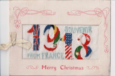 White rectangular bi-fold card with window mounted embroidery of the colours and flags of different countries in the shape of 1918.