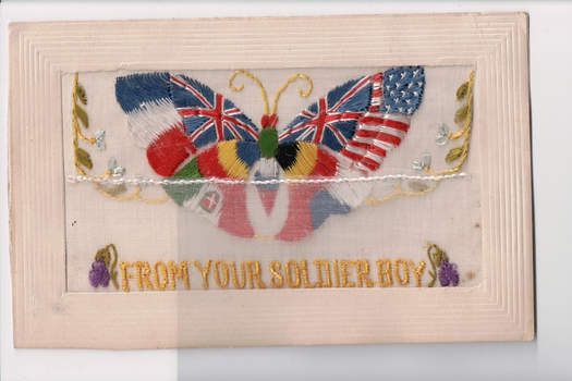 White rectangular postcard with embroidered butterfly representing the flags and colours of different countries. 