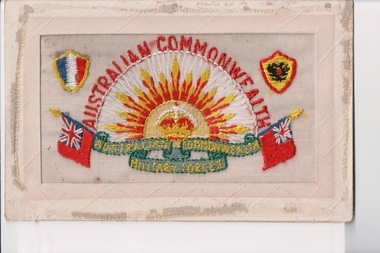 White rectangular postcard with embroidered yellow, orange, red, white rising sun badge, green banner and english maritime flags.