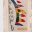 White rectangular postcard with embroidered flags.  Handwritten message on back.