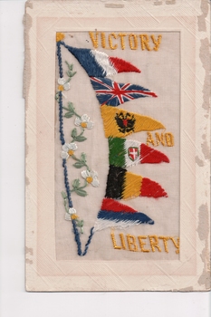 White rectangular postcard with embroidered flags.  Handwritten message on back.