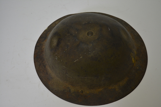 Khaki coloured metal helmet with dark brown leather plastic coated canvas inserts