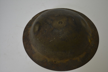 Khaki coloured metal helmet with dark brown leather plastic coated canvas inserts