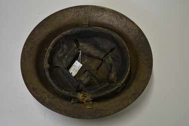 Metal helmet - Khaki in colour, with remnants of yellow paint at the front.  Inside fittings missing.