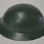 Metal helmet which has been painted dark green.  