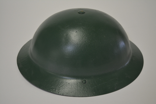 Metal helmet which has been painted dark green.  
