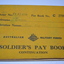 Yellow coloured cloth covered booklet with black writing and Crest in the middle of the cover.