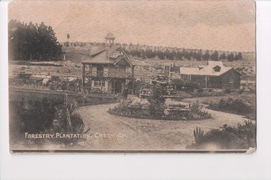 Postcard of two buildings with trees behind and circular driveway in front