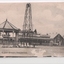 Black and white postcard of bandstand and hotel in background