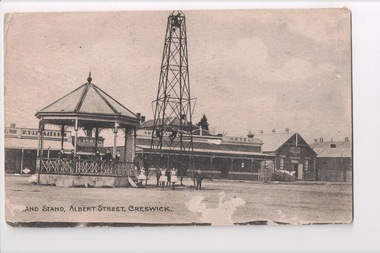 Black and white postcard of bandstand and hotel in background