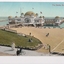 Colour postcard with a photograph of the beach and pier leading to building over water (St Kilda Baths) 