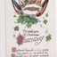 Colour postcard of a hand shake surrounded by five flags of the allies, ivy and flowers above a birthday greeting. 