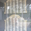 Irregular shaped marble honour roll with carved side columns and in between there are six columns of names in black