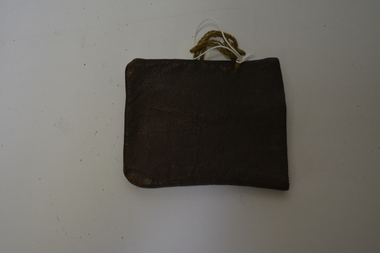 Small brown leather pouch with string attached at one side.