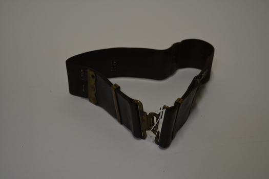 Brown leather belt with brass clip clasp and brass adjustments, brown stitching that has faded.