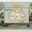 Colour postcard, blue / green colour scheme.  Map of Australia in central frame surrounded by native Australian animals in a bush setting: kangaroo, emu, currawong / magpie, kookaburra.  Above them is a rising sun.  The central frame is actually a flap but whatever it may have concealed beneath is lost.