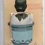 Postcard with a colour illustration of a small African child emerging from an egg.  Blue egg cup.  Yellow background with red text