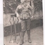 Black and white photograph of soldier wearing slouch hat leaning his right elbow on stand