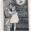 Woman holding child standing on chair with face of soldier top right of black and white postcard